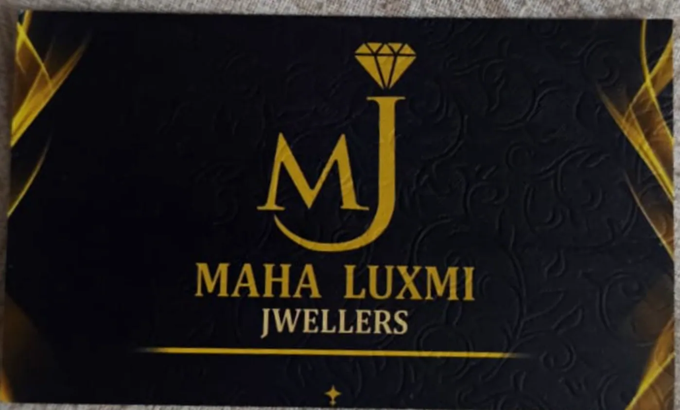 The Maha Luxmi Jwellers visiting card: a gold foil wordmark and monogram on matte black